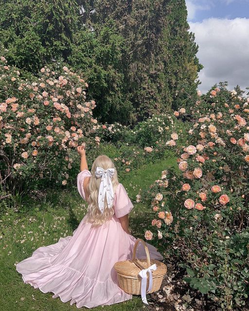 romantic girl, pretty in pink enjoying her days under the sun. reading books, having picnic and pretty dresses and bows