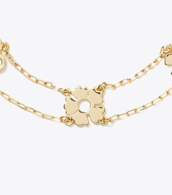 Detail ukiran gelang tory burch